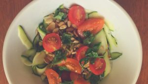 Fresh cherry tomatoes zucchini ribbons basil and toasted seeds combine to make this salad